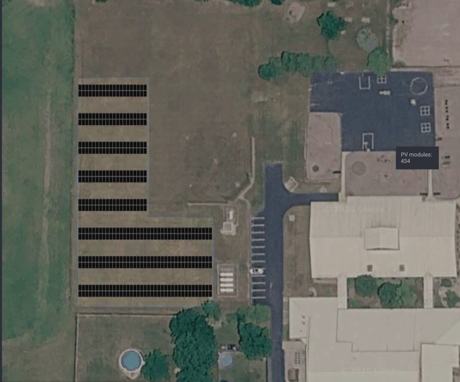 Aerial view of Grover Hill Elementary showing an L-shaped proposed solar array in the open field west of the building, labeled 434 PV modules