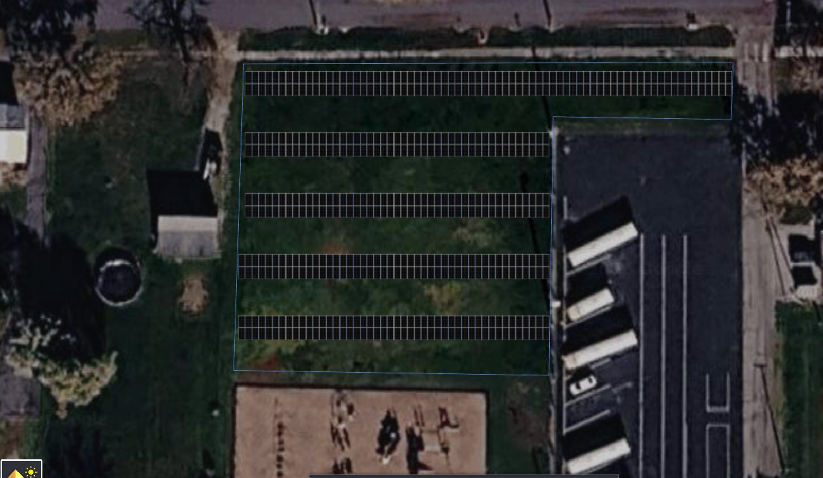 Aerial view of Payne Elementary showing proposed solar panel rows on the green space beside the building, away from the playground and buses